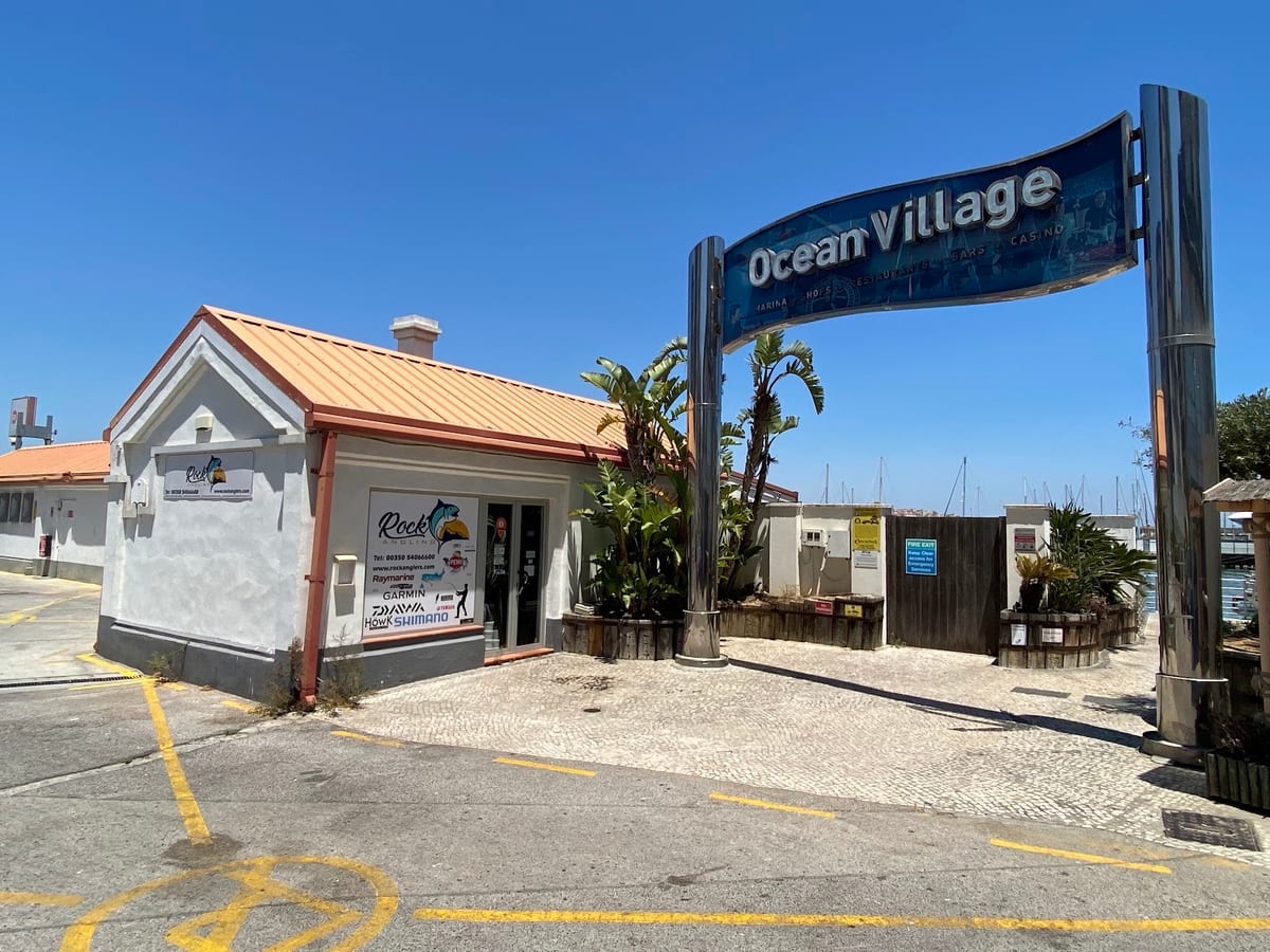 The Rock Angling unit, white with an orange roof, beside the Ocean Village sign